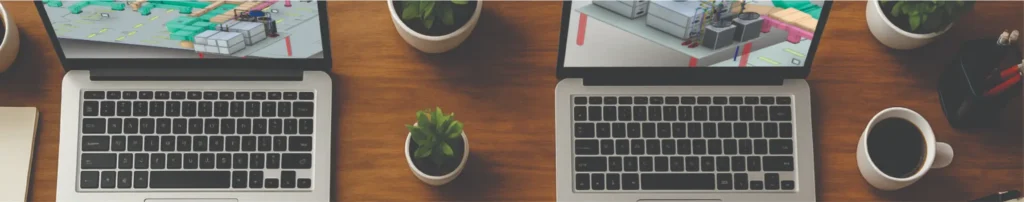 Mesa de escritório com dois notebooks exibindo modelos 3D de sistemas HVAC, plantas de climatização e objetos como café, plantas e cadernos — representando o ambiente técnico e corporativo da engenharia de climatização